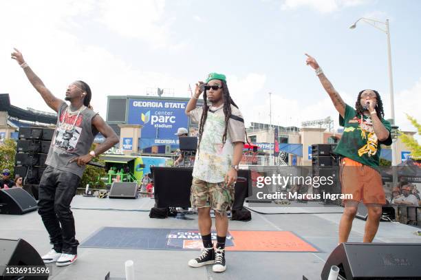 Offset, Takeoff and Quavo of Migos perform on stage during ESPN College Game Day preshow on August 28, 2021 in Atlanta, Georgia.