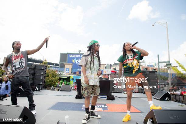 Offset, Takeoff, and Quavo of Migos perform on stage during ESPN College Game Day preshow on August 28, 2021 in Atlanta, Georgia.