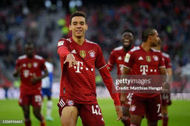 Jamal Musiala of FC Bayern Muenchen celebrates after scoring their sides third goal during the Bundesliga match between FC Bayern München and Hertha...