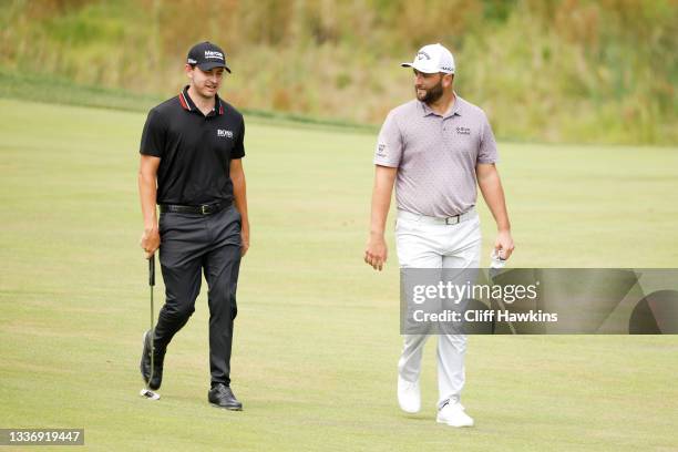 Patrick Cantlay of the United States and Jon Rahm of Spain walk on the second hole during the third round of the BMW Championship at Caves Valley...