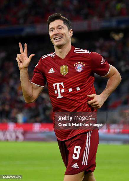 Robert Lewandowski of FC Bayern Muenchen celebrates after scoring their sides fifth goal for their hat trick during the Bundesliga match between FC...