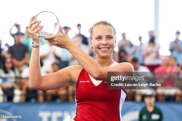 Anett Kontaveit of Estonia holds up her trophy after winning her finals match against Irina-Camelia Begu of Romania on day 7 of the Cleveland...