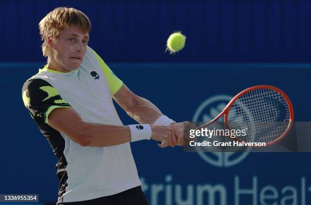 Ilya Ivashka of Belarus returns a shot to Mikael Ymer of Sweden during the finals of the Winston-Salem Open at Wake Forest Tennis Complex on August...