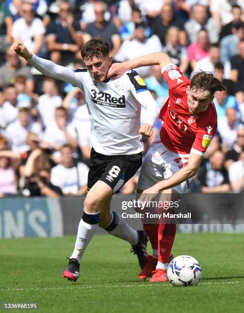 Max Bird of Derby County is challenged by James Garner of Nottingham Forest during the Sky Bet Championship match between Derby County and Nottingham...