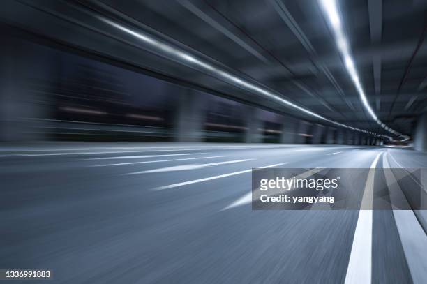 modern highway tunnel underpass at night - road motion stock pictures, royalty-free photos & images