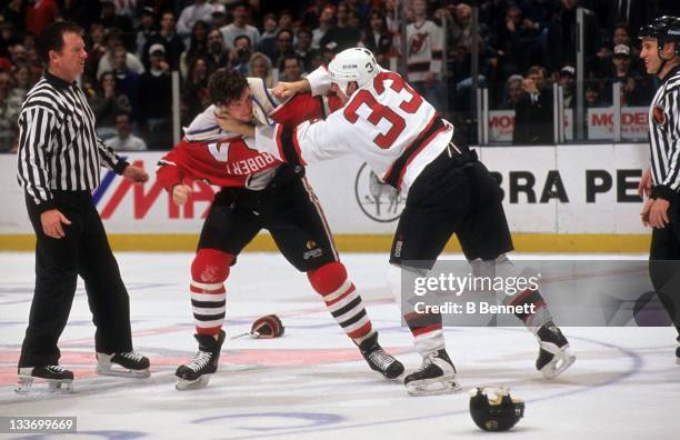 Bob Probert of the Chicago Blackhawks fights with Reid Simpson of the New Jersey Devils circa 1995 at the Continental Airlines Arena in East...