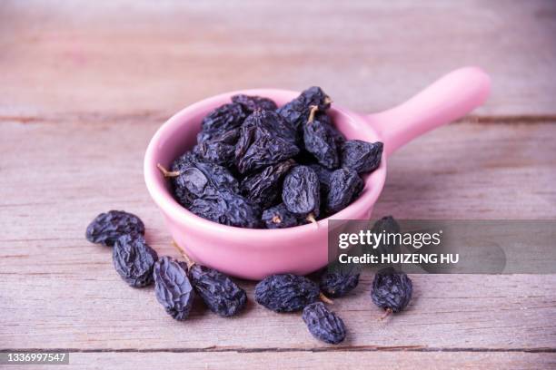 black raisins - raisin stock pictures, royalty-free photos & images