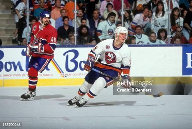 Brian Mullen of the New York Islanders and J.J. Daigneault of the Montreal Canadiens skate on the ice during a 1993 Conference Finals game in May,...