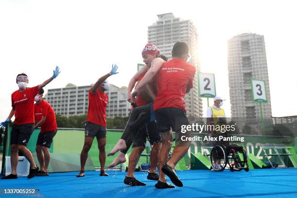 Emily Tapp of Australia is helped out of the water in the Women's PTWC Triathlon at Odaiba Marine Park on day 5 of the Tokyo 2020 Paralympic Games at...