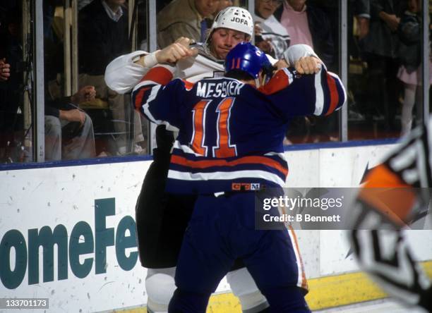 Marty McSorley of the Los Angeles Kings fights with Mark Messier of the Edmonton Oilers on February 28, 1990 at the Great Western Forum in Inglewood,...