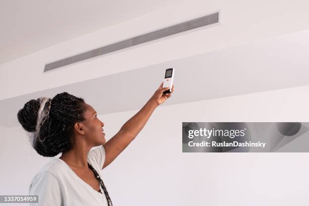 turning on / off the air conditioner. - remote controlled stock pictures, royalty-free photos & images