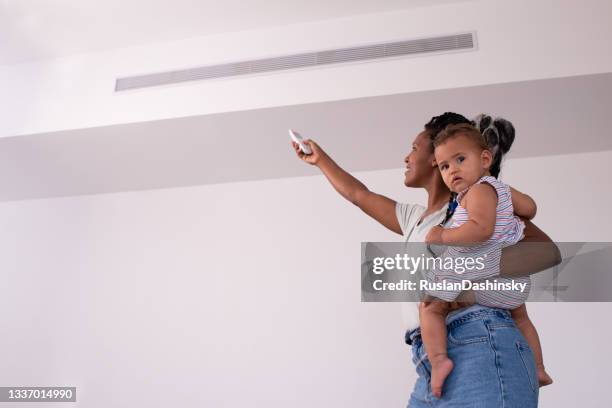 turning on / off the air conditioner. - infant ventilator stock pictures, royalty-free photos & images