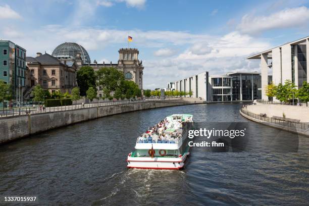 reichstag building (deutscher bundestag) with tourboat - (berlin, germany) - tourboat stock pictures, royalty-free photos & images