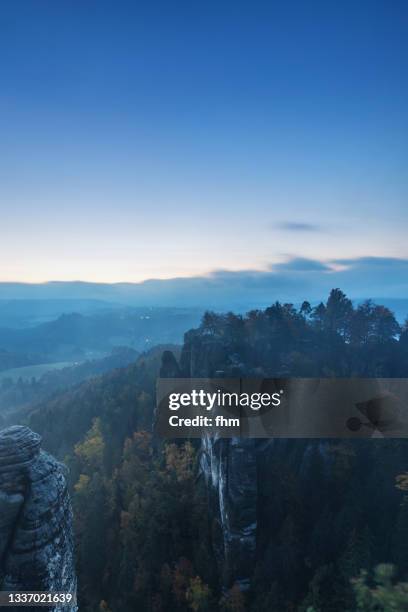 landscape in the elbe sandstone mountains at blue hour (german: elbsandsteingebirge), saxony/ germany - blue hour stock pictures, royalty-free photos & images