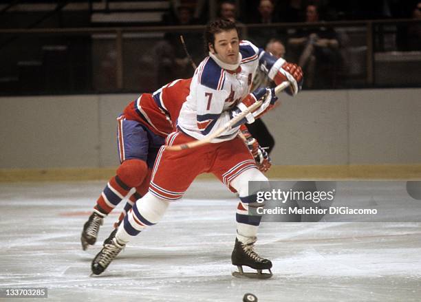 Rod Gilbert of the New York Rangers goes for the puck during an NHL game against the Montreal Canadiens circa 1974 at the Madison Square Garden in...