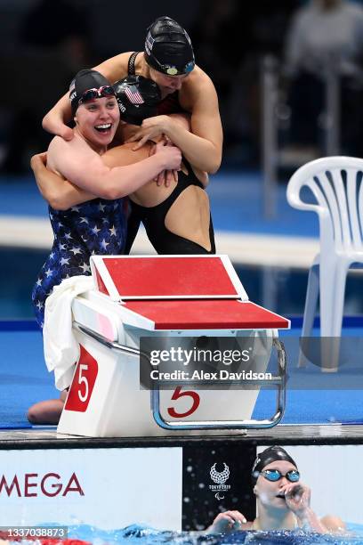 Morgan Stickney, Jessica Long and Natalie Sims of Team United States celebrate with Hannah Aspden of Team United States in the water after they...