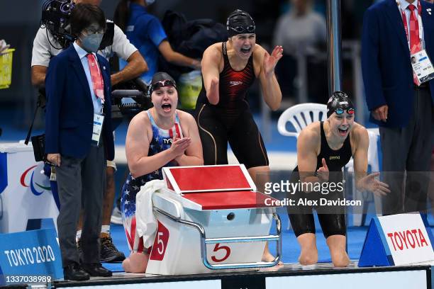 Morgan Stickney, Natalie Sims and Jessica Long of Team United States encourage Hannah Aspden of Team United States in the water as they finished in...