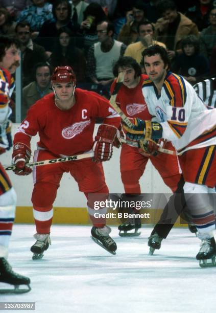 Marcel Dionne of the Detroit Red Wings and Guy Charron of the Kansas City Scouts look for the puck after the faceoff during their game on January 4,...