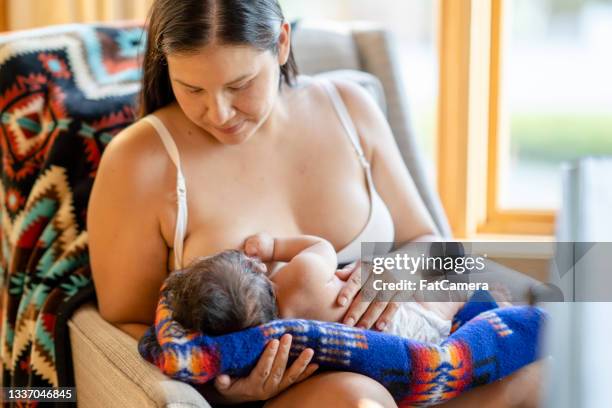close up photo of a beautiful young mother breastfeeding her newborn baby - indian food bildbanksfoton och bilder