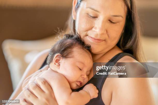 cute baby girl sleeping on her mother's chest - infödd amerikan bildbanksfoton och bilder