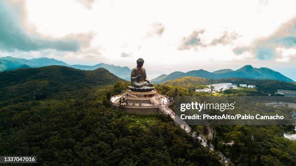 view of tian tan buddha at po lin monastery - hong kong stock pictures, royalty-free photos & images