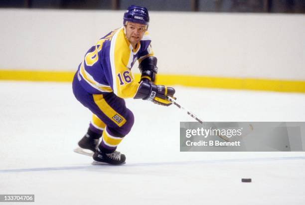 Marcel Dionne of the Los Angeles Kings skates with the puck during an NHL game circa 1982.