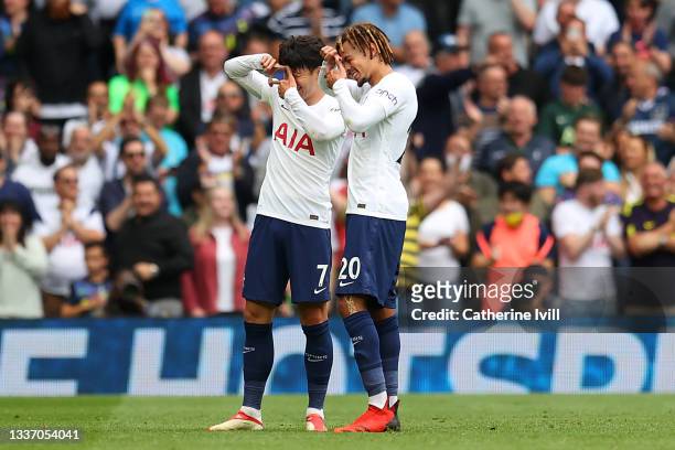 Heung-Min Son of Tottenham Hotspur celebrates after scoring their sides first goal with team mate Dele Alli during the Premier League match between...