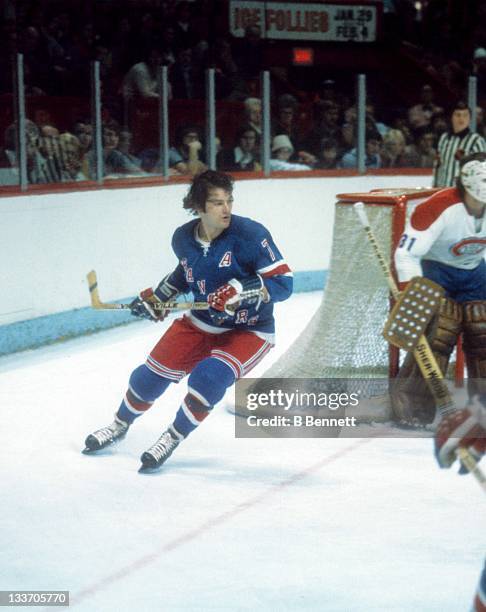 Rod Gilbert of the New York Rangers skates around the net during an NHL game against the Montreal Canadiens circa 1977 at the Montreal Forum in...