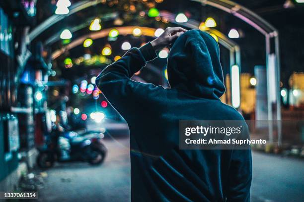 someone who stands at night - indonesia street stock pictures, royalty-free photos & images