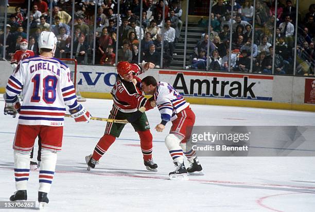 Ken Daneyko of the New Jersey Devils fights with Tie Domi of the New York Rangers on February 13, 1991 at the Madison Square Garden in New York, New...