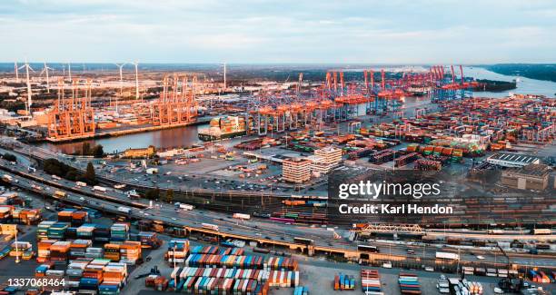 an aerial sunrise view of hamburg docks and shipping containers stacked up in a port - stock photo - hamburg germany stockfoto's en -beelden