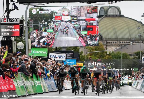 Alexander Kristoff of Norway and UAE Team Emirates celebrates winning ahead of Pascal Ackermann of Germany and Team Bora - Hansgrohe, Luca Mozzato of...