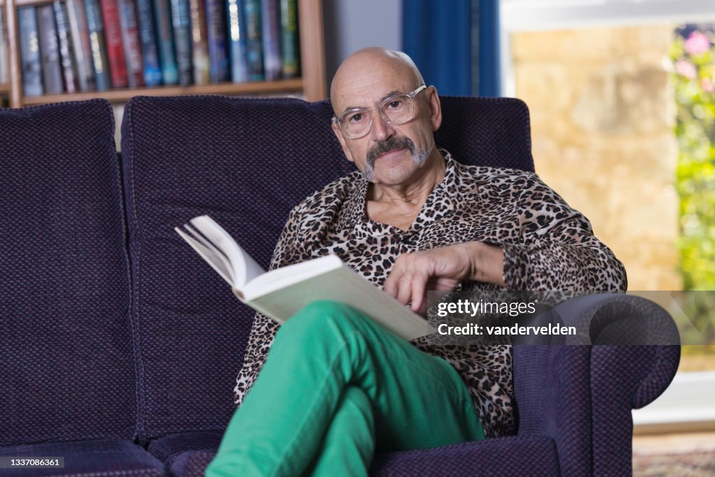 Senior gay man reading in his study