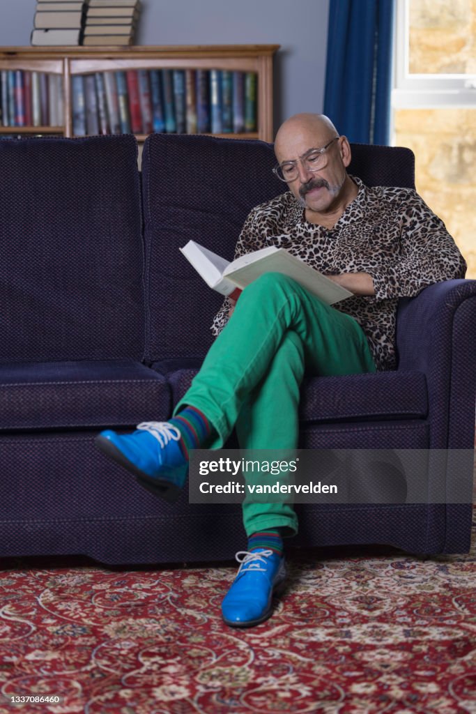 Senior gay man reading in his study