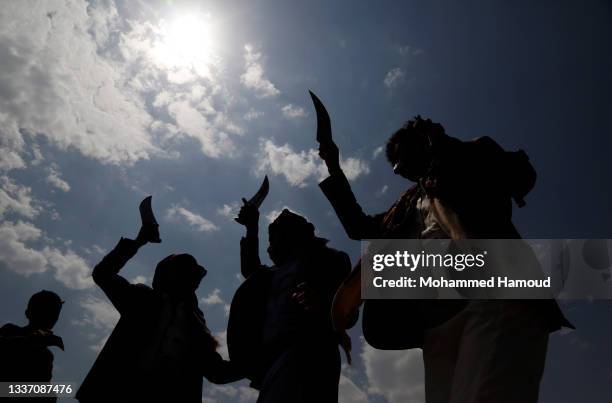 People perform Yemen's traditional dance called 'Barra' during a wedding celebration of their relative groom at al-Sabeen Square on August 29, 2021...