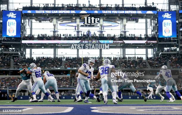 Quarterback Cooper Rush of the Dallas Cowboys hands the ball off to cornerback Israel Mukuamu of the Dallas Cowboys against the Jacksonville Jaguars...