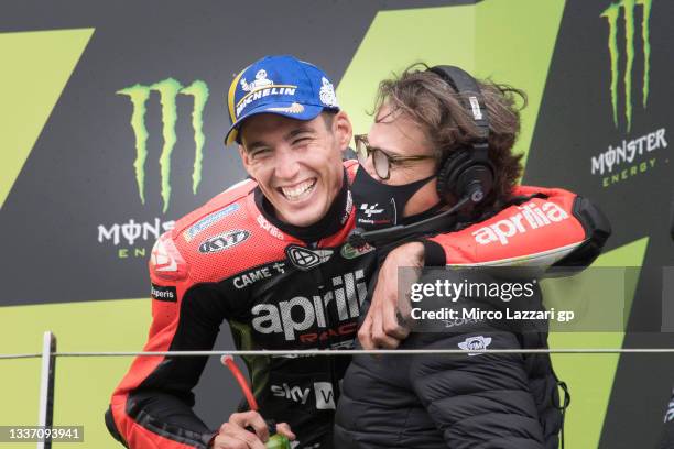 Aleix Espargaro of Spain and Aprilia Racing Team Gresini celebrates with Ignacio Sagnier of Spain and Director Communications Department Dorna on the...