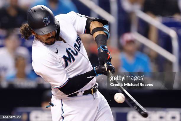 Jorge Alfaro of the Miami Marlins breaks his bat against the Cincinnati Reds during the third inning at loanDepot park on August 29, 2021 in Miami,...