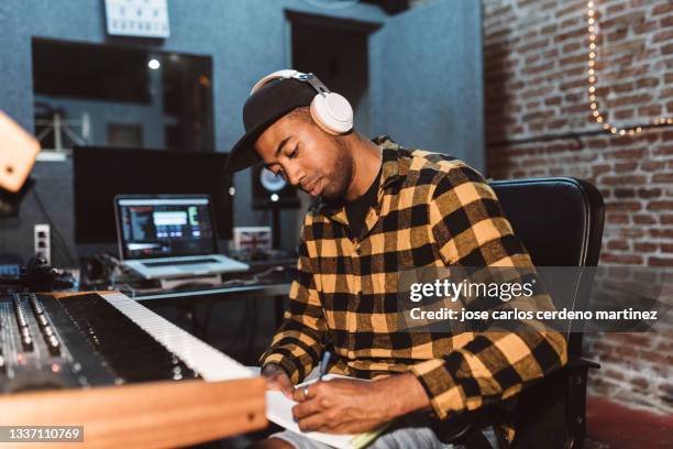 rapper in a recording studio composing songs - personal stereo stockfoto's en -beelden