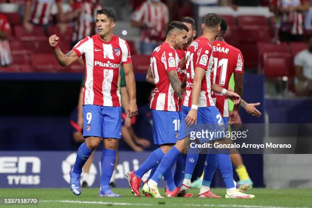 Luis Suarez of Atletico Madrid celebrates with teammates after scoring their team's first goal during the La Liga Santander match between Club...