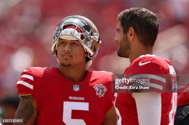 Jimmy Garoppolo and Trey Lance of the San Francisco 49ers talk to each other on the sidelines before their preseason game against the Las Vegas...