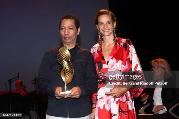 Director Philippe Lacote poses with the award of "Valois de la mise en scène" for "La Nuit des rois" next to Noémie Schmidt during the closing...