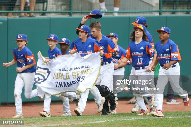 Team Michigan players celebrate winning the 2021 Little League World Series championship game against Team Ohio at Howard J. Lamade Stadium on August...