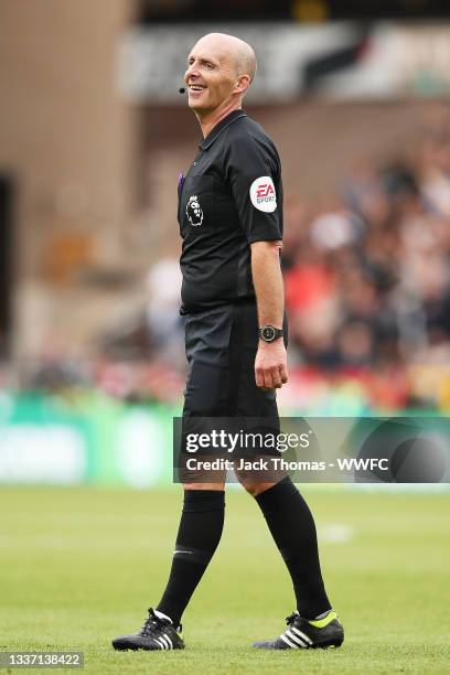 Referee Mike Dean looks on during the Premier League match between Wolverhampton Wanderers and Manchester United at Molineux on August 29, 2021 in...