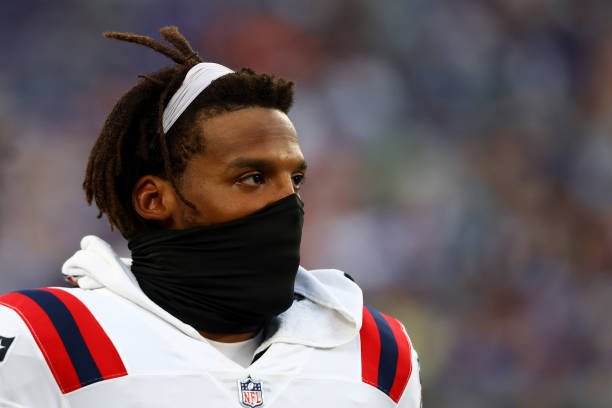 Cam Newton of the New England Patriots looks on from the bench during the game against the New York Giants at MetLife Stadium on August 29, 2021 in...