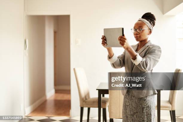 real estate agent using a tablet to do a video walk-through of a home - video reviewed stock pictures, royalty-free photos & images