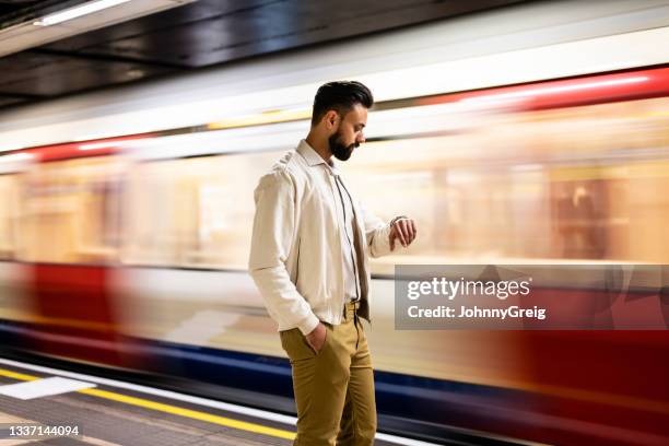 early 30s london businessman waiting for his train - commuter train stock pictures, royalty-free photos & images