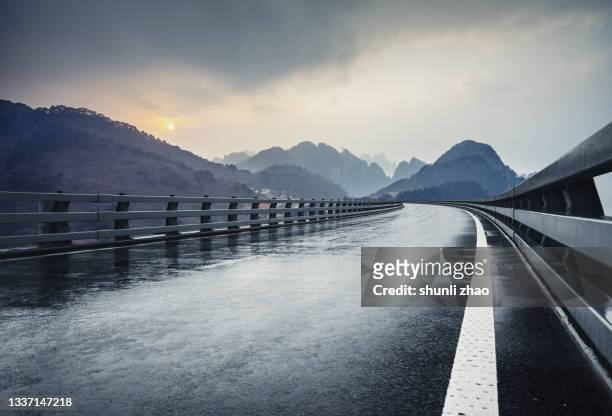 expressway in the mountains after the rain - land boundary stock pictures, royalty-free photos & images