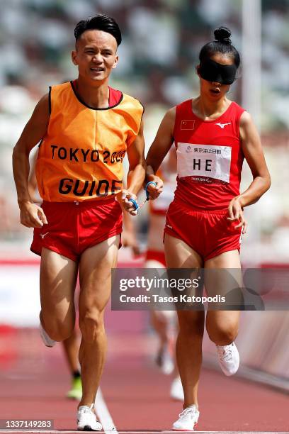 Shanshan He and guide Ziqin Huang of Team China compete in the women's 1500m - T11 final on day 6 of the Tokyo 2020 Paralympic Games at Olympic...