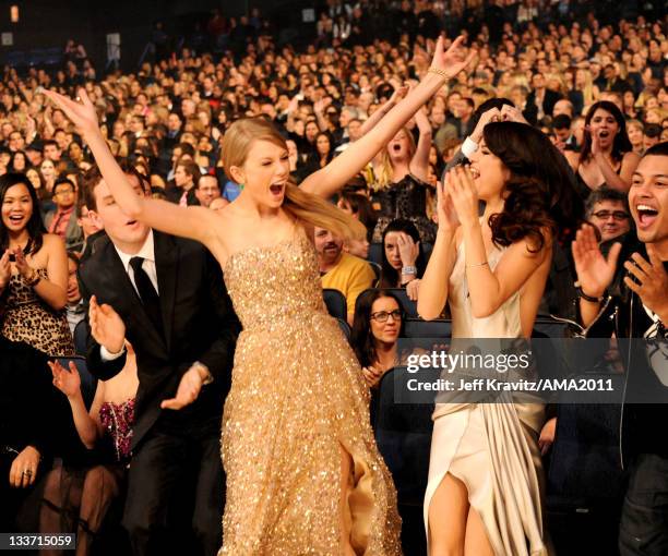 Taylor Swift and Selena Gomez celebrate her winning an award at the Nokia Theatre L.A. LIVE on November 20, 2011 in Los Angeles, California.